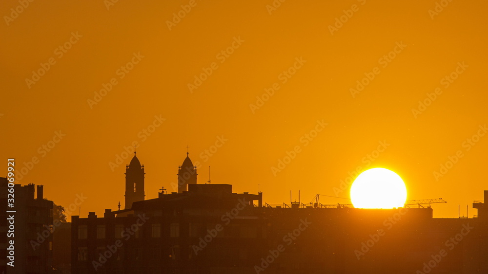 Sunrise over roofs of Porto from bridge at Douro river timelapse. World famous Porto wine production area.