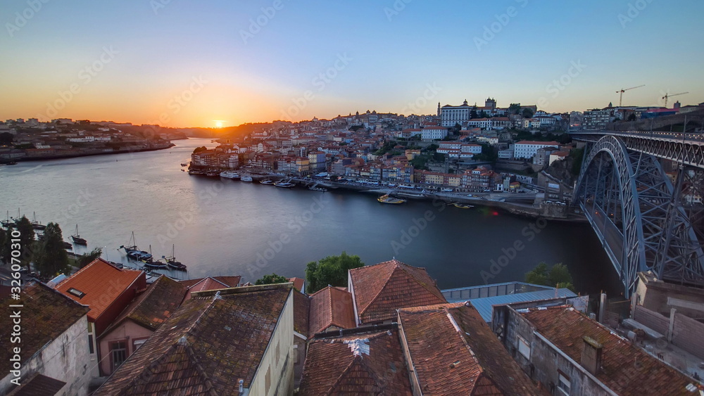 Panorama old city Porto at river Duoro,with Port transporting boats at sunset timelapse, Oporto, Portugal