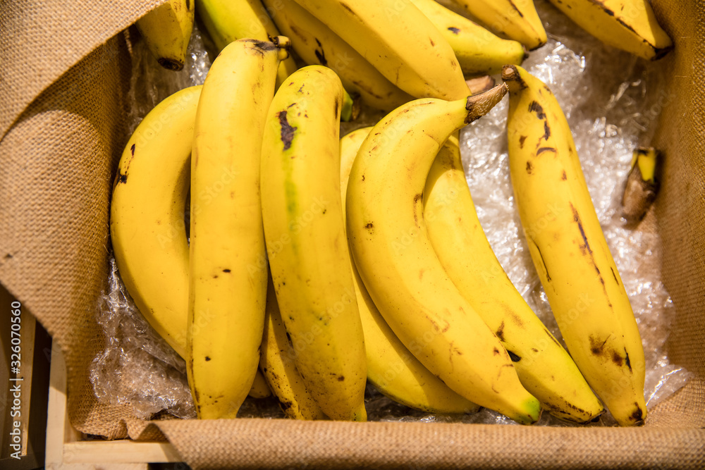 Closeup of bananas in box on shelf in supermarket