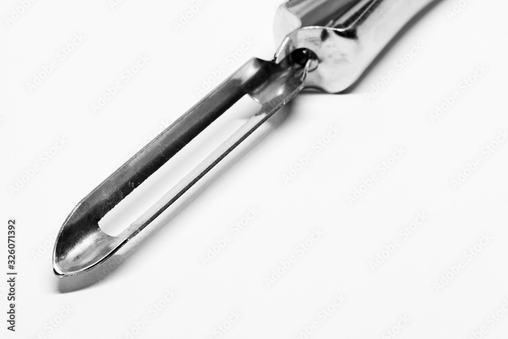 a potato peeler in black and white with a sharp tip a potato peeler in black and white with a sharp tip