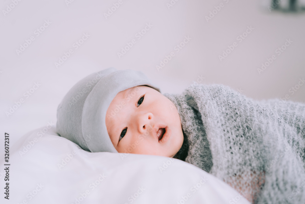 Smiling baby boy lying on a white bed, Family morning at home,Children hygiene. Smiling baby boy lying on a white bed, Family morning at home,Children hygiene.