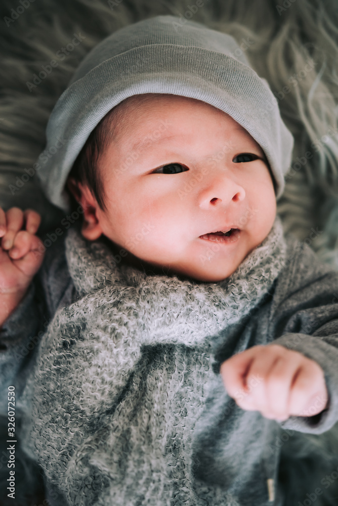 Portrait of baby boy lying on a white bed with hat and scarf , Family morning at home,Children hygiene. Portrait of baby boy lying on a white bed with hat and scarf , Family morning at home,Children hygiene.