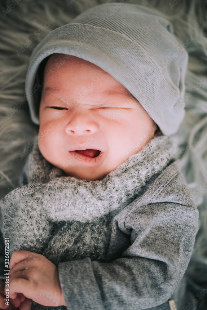 Portrait of baby boy lying on a white bed with hat and scarf , Family morning at home,Children hygiene. Portrait of baby boy lying on a white bed with hat and scarf , Family morning at home,Children hygiene.