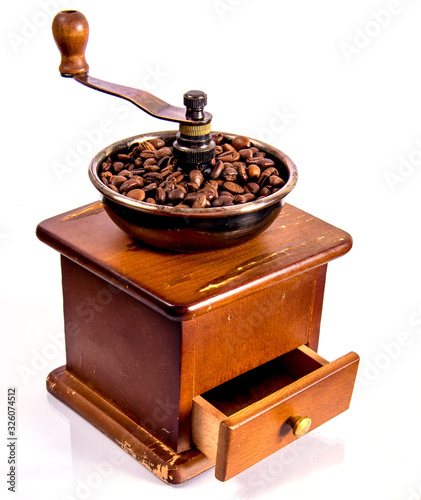 Old coffee grinder with coffee beans, on a white background, isolated, space for text