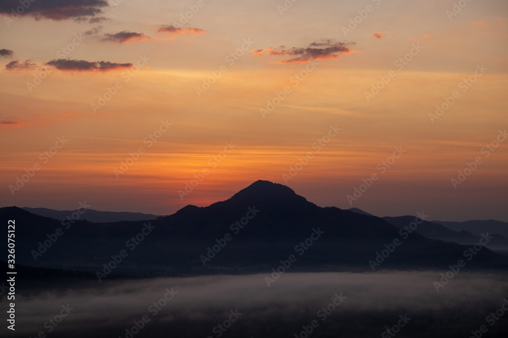 The sunrise with mountains and clouds