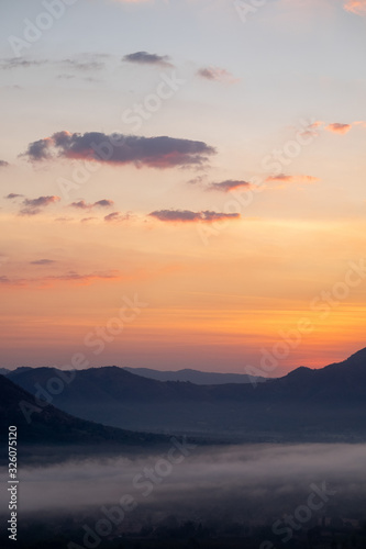The sunrise with mountains and clouds