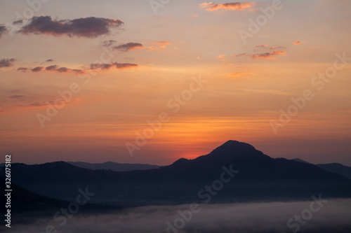 The sunrise with mountains and clouds