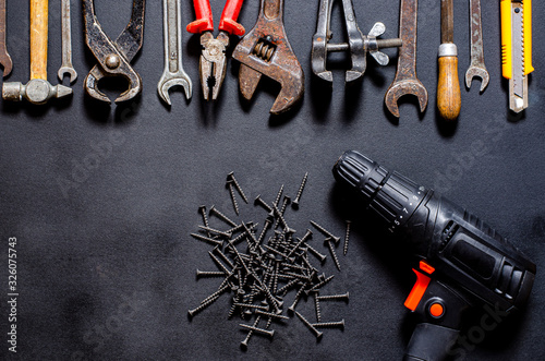 Construction worker tools on a dark background top view.