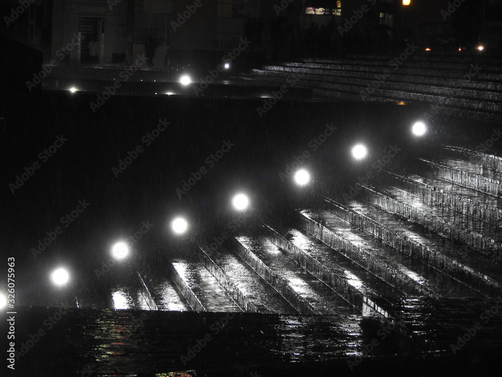 illuminated stairs at night during the rain
