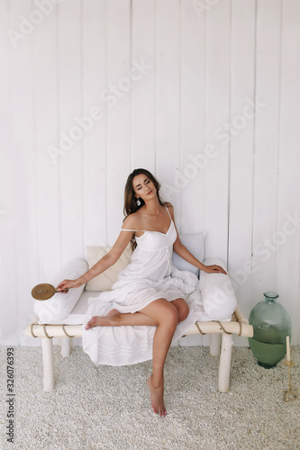 Portrait of a young beautiful woman. Bride in elegant classic wedding dress. Morning of the bride. Wedding preparations.
