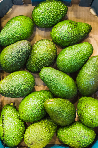 Exhibition of green avocados for sale