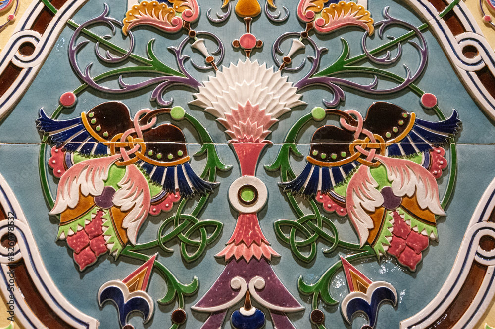 Fototapeta premium Ceramics with hand painted traditional patterns. Detail of the traditional tiles azulejos from facade of old house in Lisbon, Portugal