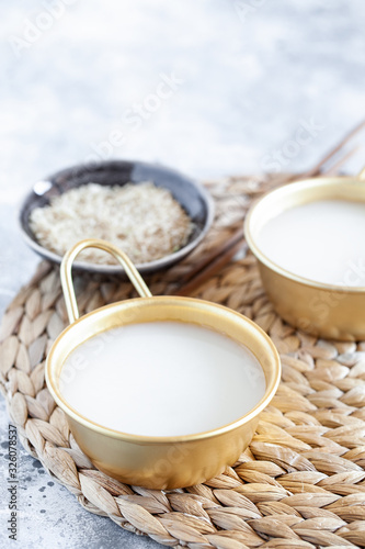 Makgeolli rice wine is one of the oldest korean traditional fermented alcoholic drinks close-up. Healthy asian boozy beverage. Vertical orientation. Selective focus