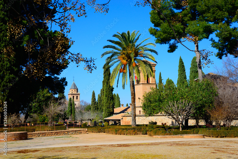Fototapeta premium Granada, Spain - February 20, 2020: Gardens and facade of the Parador de San Francisco, The Alhambra in Granada.