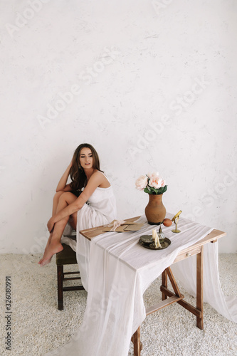 Portrait of a young beautiful woman. Bride in elegant classic wedding dress. Morning of the bride. Wedding preparations.