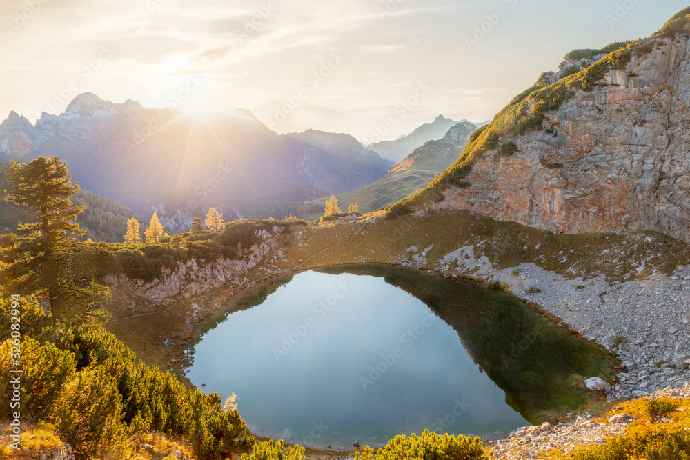 Mountain landscape with lake in the alps at sunset