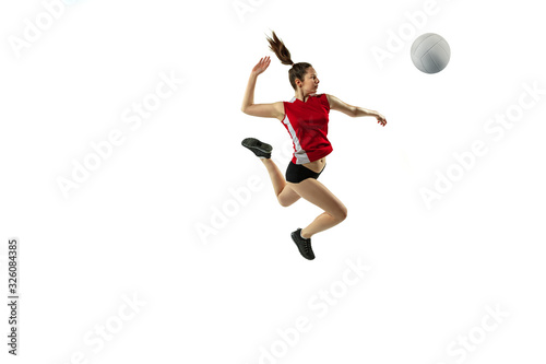 In jump and flight. Young female volleyball player isolated on white studio background. Woman in sportswear and sneakers training, playing. Concept of sport, healthy lifestyle, motion and movement. © master1305