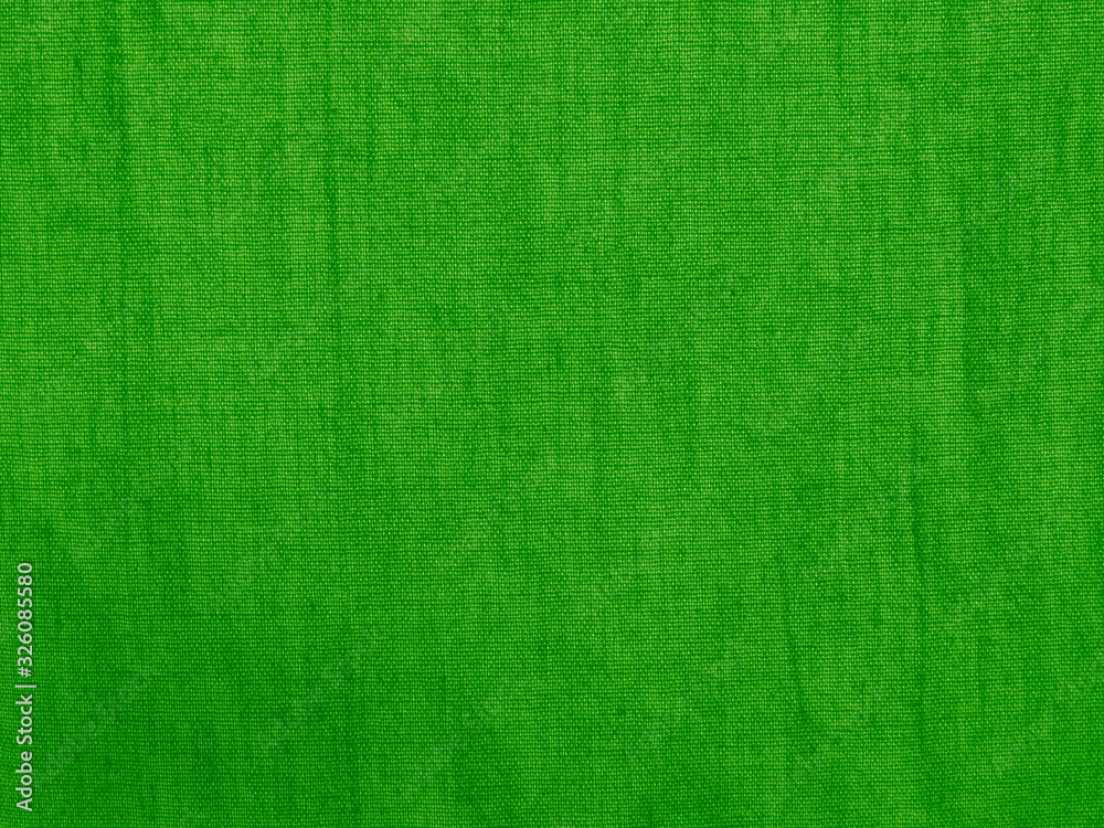 Green cloth background. Rough cotton fabric texture. Bright green abstract natural background. Green cloth background. Rough cotton fabric texture. Bright green abstract natural background.