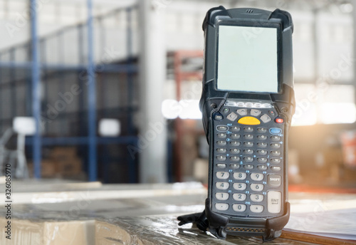 Bluetooth barcode scanner with package boxes in warehouse.
