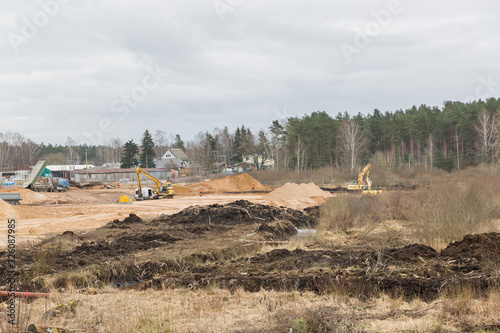 City Riga, Latvia.Construction site with tractors working and moving sand. photo