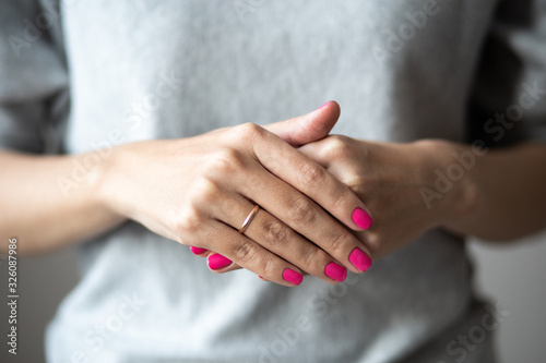 Closeup photo of manicure, women hands with perfect pink polish