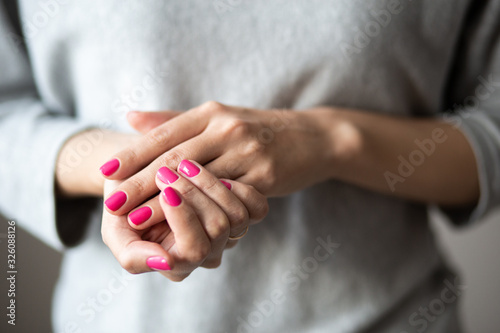Closeup photo of manicure  women hands with perfect pink polish
