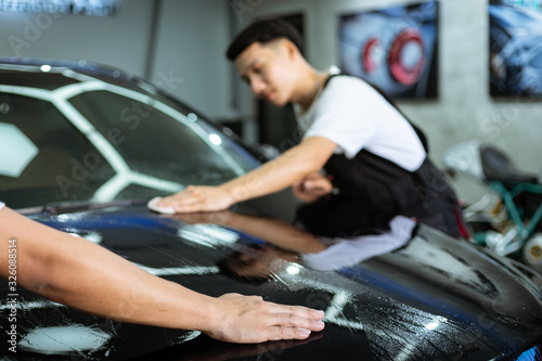 Car cleaning auto service : the man cleaning and polishes. car detailing concepts. Selective focused © littlekop