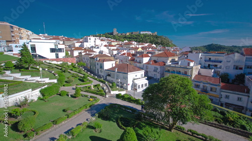 Castle with houses with red roof near the city Sesimbra, Atlantic coast of Portugal timelapse
