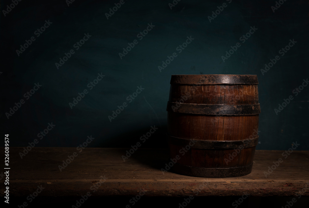 Fototapeta premium Wooden barrel on a table and textured background