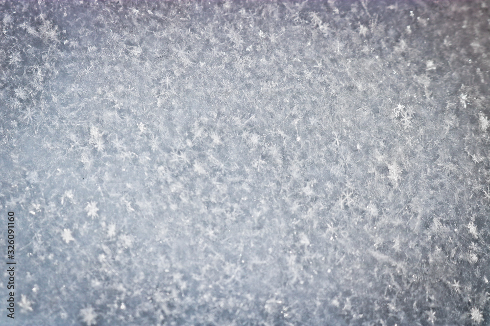 The texture of freshly fallen snow. Christmas template for design. Clearly visible individual snowflakes. Winter background. The texture of freshly fallen snow. Christmas template for design. Clearly visible individual snowflakes. Winter background.