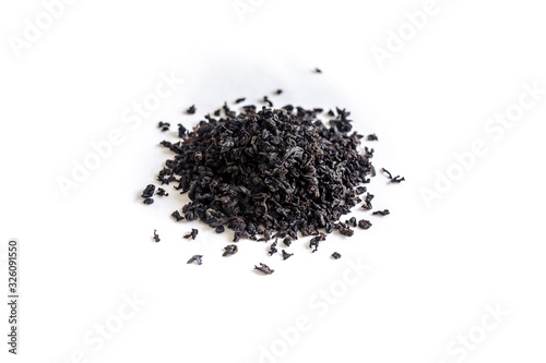 different sorts of black or green tea in bulk on a white background close-up isolated
