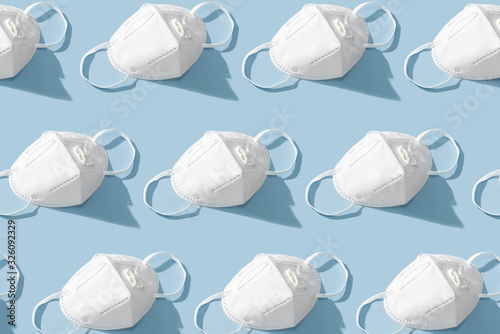 Flat lay composition with protective white face mask on color background