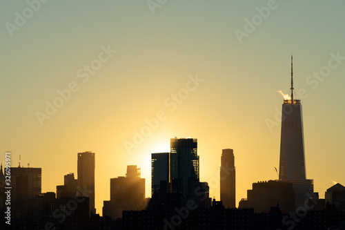 Lower Manhattan Skyline in New York City during Sunset with Silhouettes of Skyscrapers © James