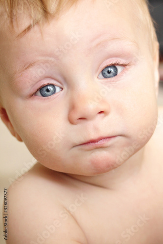 Funny Stare and Face of a Cute 8 Month Old Baby with Blue Eyes