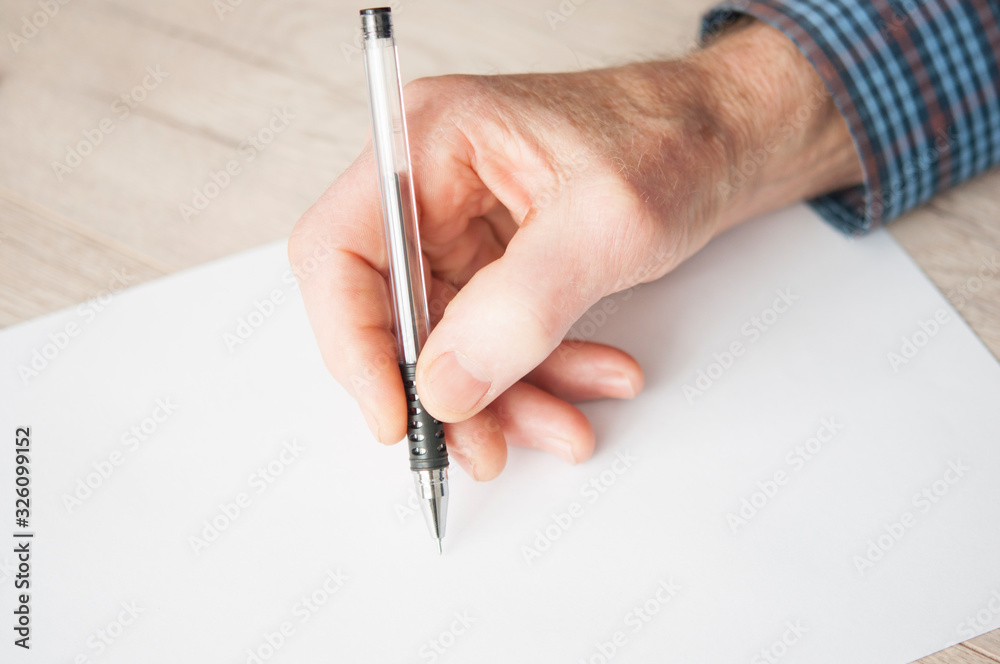 Elderly male right hand ready to start writing. Elderly male right hand ready to start writing.