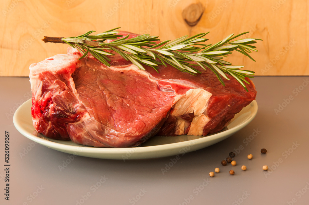 Raw beef fillet steaks with herbs and spices Raw beef fillet steaks with herbs and spices