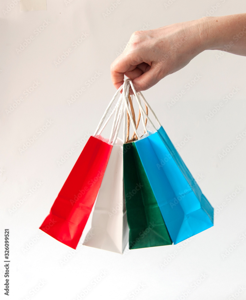 colorful paper bags with handles on a white background