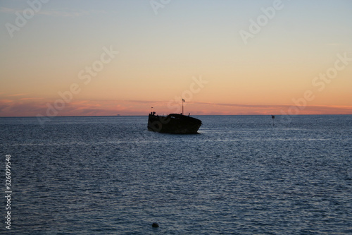 boat at sunset © derpomic