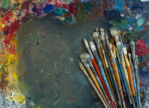 Workplace painter palette with colors and brushes. Palette of colors, creative disorder, art.