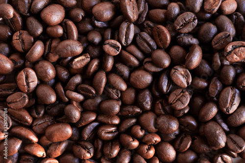 Coffee beans background. Large arabica beans on the table. 