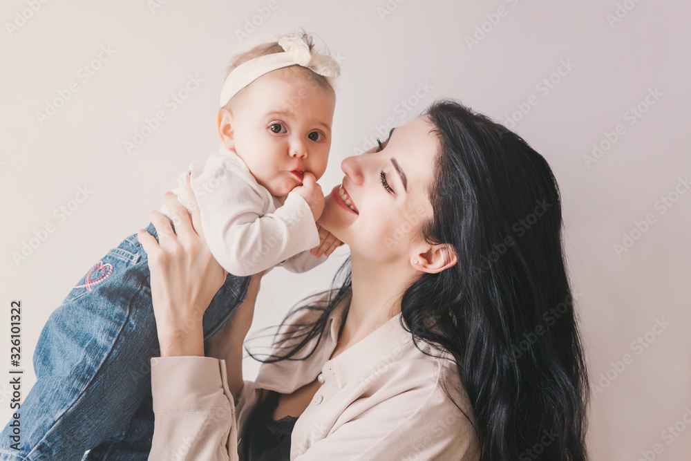 Mom and baby girl playing in sunny room. Mom and baby girl playing in sunny room.
