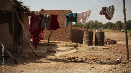 Laundry drying in poor drought village house, India, close up, shallow DOF