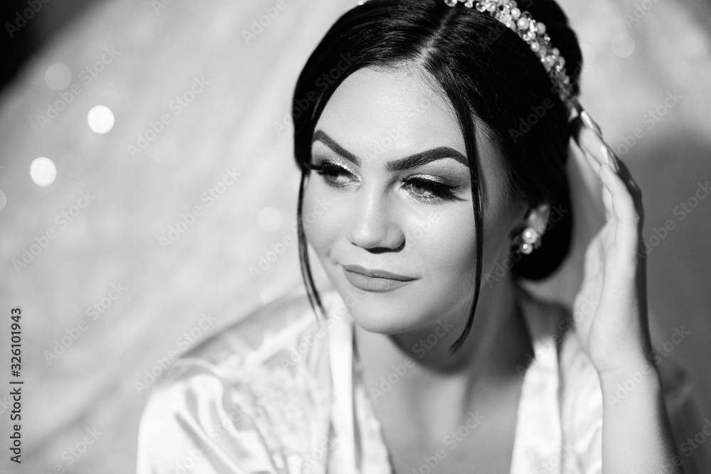 Beautiful sexy and fashionable brunette bride in the bedroom - wedding preparation of the young stylish bride in robe. 