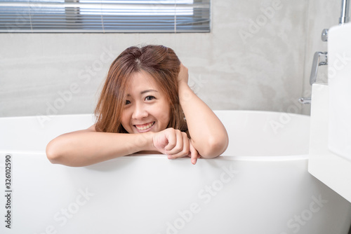 Portrait of young attractive asian girl takes a bath with candles relax in the bathroom. Beauty woman in spa treatments. Healthy perfect glow skin care concept