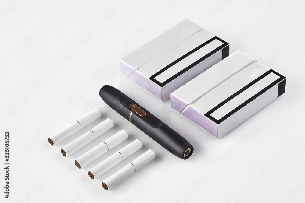 New generation black electronic cigarette, two packs with purple sides and five heatsticks isolated on white. Heating tobacco system. Close up New generation black electronic cigarette, two packs with purple sides and five heatsticks isolated on white. Heating tobacco system. Close up