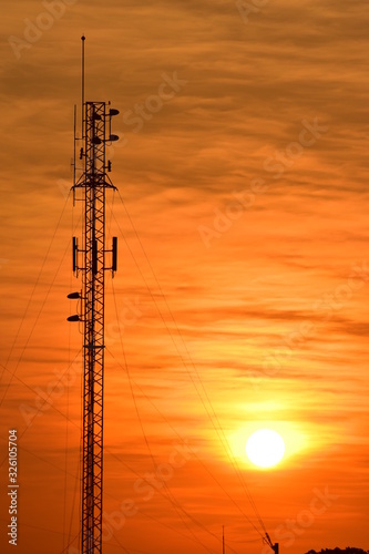 Wireless telephone pole and orange-yellow sky In the early morning of the day	