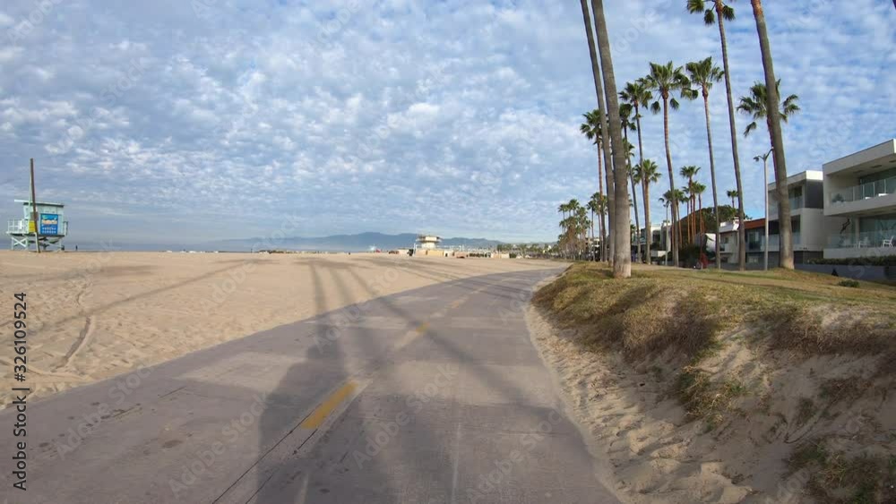 Early morning ride past homes and palm trees on the Venice beach bike path in Southern California. Early morning ride past homes and palm trees on the Venice beach bike path in Southern California.