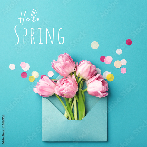 Bunch of pink tulips in turquoise envelope on turquoise background decorated ...