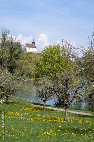 RHEINAU, SWITZERLAND - APRIL 4, 2018: The spring landscape in Rheinau with a little chapel photo