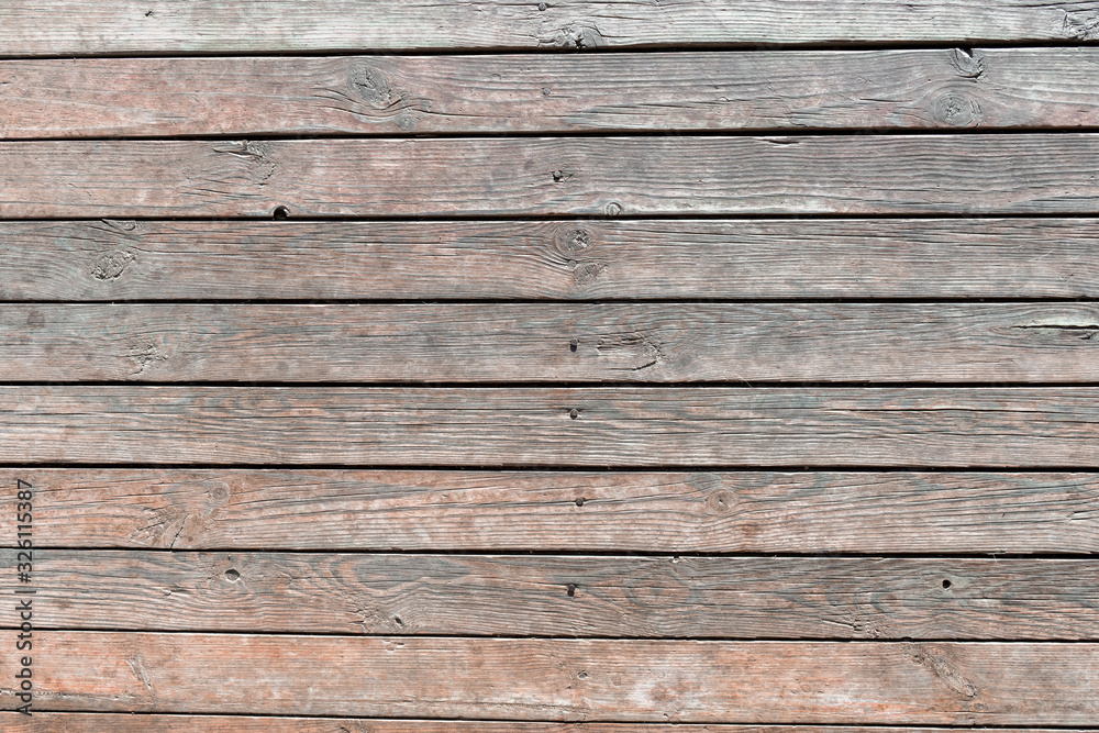 Close-up of wooden texture of wall boards driven in with rusty nails, weathered planks with deep cracks and worn brown paint. Abstract rustic background for design, blank template Close-up of wooden texture of wall boards driven in with rusty nails, weathered planks with deep cracks and worn brown paint. Abstract rustic background for design, blank template